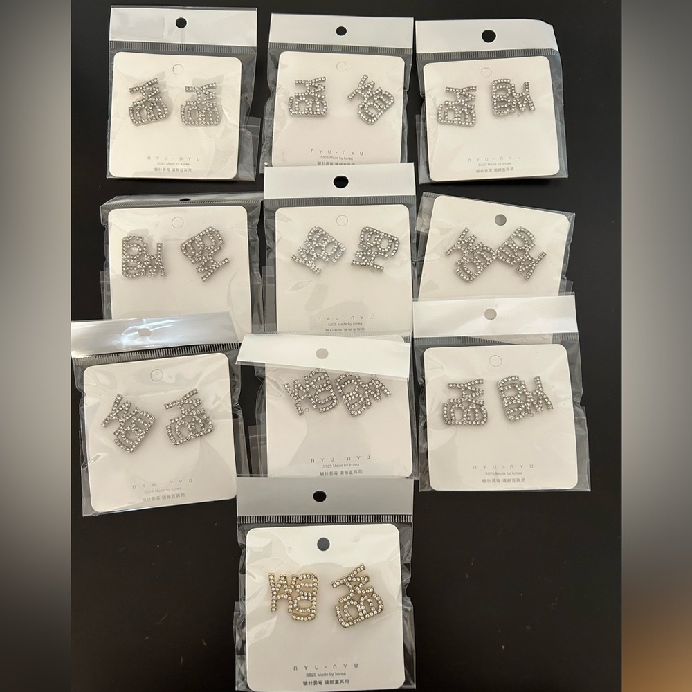 Set of 10 WANG rhinestone earrings - 9 silver + 1 gold